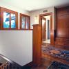 This view from top of stairs shows new landing and storage.  We modeled original carpentry details on first floor, and continued them upstairs in reconfigured rooms.