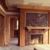 Living room during construction shows woodwork before it was refinished.  Sagging joists have been reinforced, and a new ceiling installed.  Sunroom is beyond fireplace.