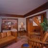 This view of restored living room taken at night includes doorway to entry hall on the right and dining room beyond.