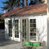 Sunroom was built with cedar board and batt walls, to contrast with stucco garage.  This view was taken during construction.