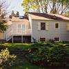 Backyard view after renovation with ridge extending across the main body of the house.  Smaller gables are subordinate, and appear to be later additions.  Window muntins, shutters and railings  provide small-scale details that were missing.