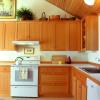 Kitchen remains in its original location, but doors to dining room and basement stair were moved.  By separating them we had room to build a third wall of cabinets, and provide work triangle between sink, range and fridge.