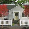 View of completed house from the street.  New shingle roofs have barn ridge with end finials.  Brick chimney was painted white.  Picket fence is gorgeous clear red cedar with semi-transparent stain.