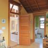 Master bedroom entry has transom above door, a traditional method to ventilate tall rooms and borrow natural light. Former closet was made into a new bathroom.