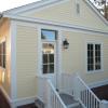 Back view of cottage shows stair to garden.  Siding is fiber cement with 4" exposure, and exterior trim is borate-treated pine.  These are durable materials, and less expensive than traditional red cedar.