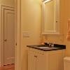 Bath has a custom console and medicine cabinet that we designed.  Tile floor is Carrara marble.  Flat ceilings are 9' high, allowing room for transoms above doors.