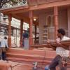 We found when the porches were enclosed original seven foot tall turned columns were removed.  Our new redwood columns were turned using largest industrial lathe we could find.