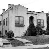 1930s photo shows original one story bungalow with flat roof and parapets.  Houses like this were very popular in California, but less so in soggy Northwest.  Walls are masonry veneer over wood frame with stucco finish.