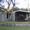 View from southwest shows sycamore tree in corner of addition. Cantilevered roof provides a shaded terrace in hot summer months. 