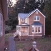 This view of "Garden House" is from stair to apartment above garage.  Buildings have lightly stained red cedar siding with Zincalume corrugated roofs.