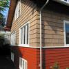 Deep overhangs had protected siding for over 100 years.  Original cedar bevel siding was patched and restored. Note flared shingles above windows.  We replicated original detail used by builders to protect first floor windows in gable ends.